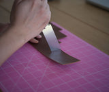 Precision leathercraft knife made with Böhler M390 powder steel for clean cutting, beveling, and fine decorative grooves. Features an ergonomic purple sandalwood handle and balanced HRC 60–62 hardness. Built for serious leatherworkers. Explore the tool today.