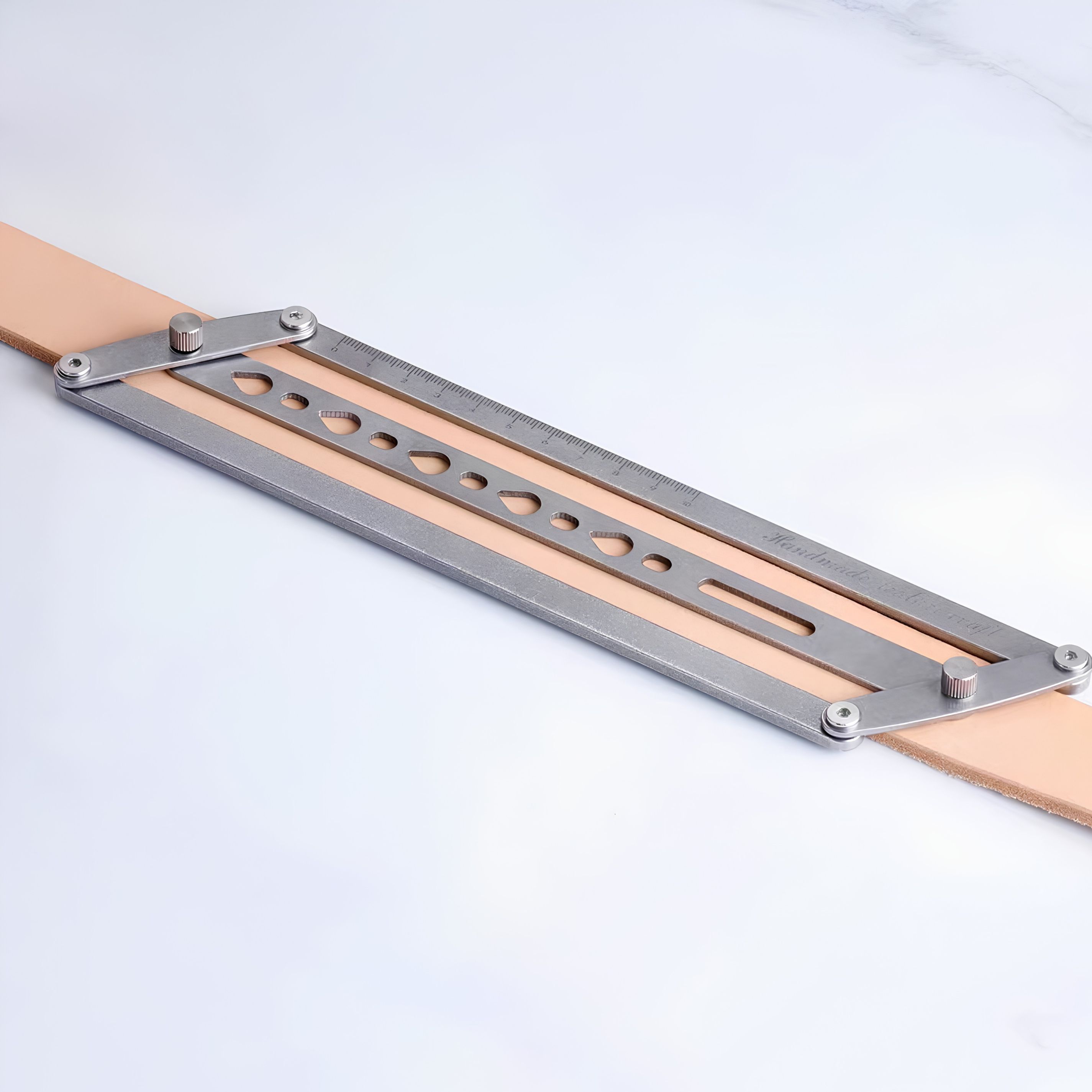 Adjustable leather belt hole positioning ruler with self-centering parallel guides and teardrop punch holes for clean, straight hole marking on belts, straps, bags, watch straps, and pet collars. Lockable, easy to align, and built for consistent leatherwork. Shop now.