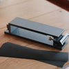 Aluminum sandpaper sharpening base for leathercraft knives and edge tools. CNC-machined with an anodized finish, non-slip silicone backing, and a flat clamping design for easier, more consistent sharpening. Includes 600, 1200, and 2000 grit sandpaper. Shop now.