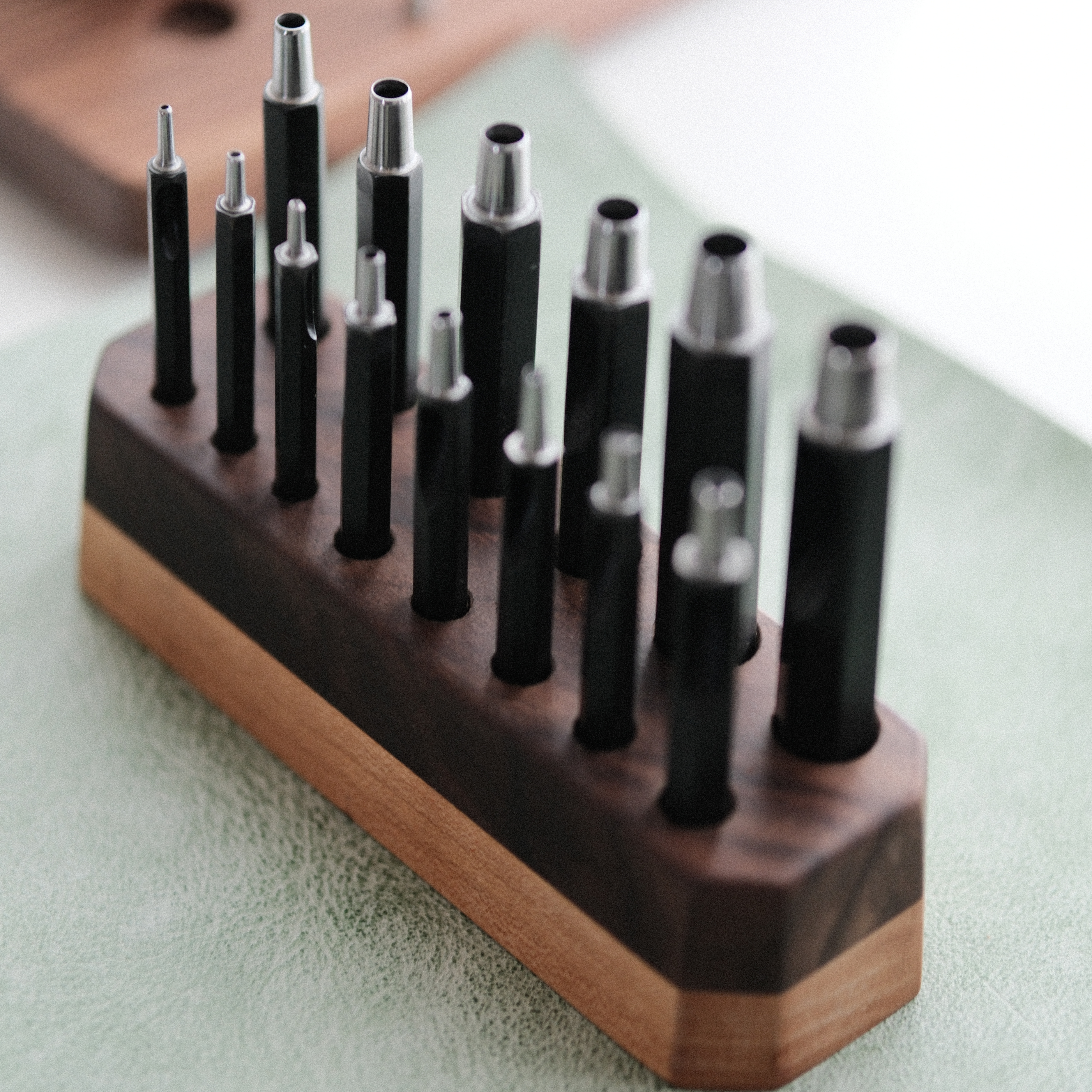 Taiwan-made Bangbang hex round punch set for leathercraft. High-toughness special alloy steel punches with black finish and wooden base, ideal for clean belt holes, hardware holes, and round leather punching.