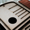 Leather pencil roll cutting die with integrated stitching holes, Japanese steel blade, and wood or acrylic base. Designed for clean, repeatable cutting with a protective pencil-tip flap. Custom layouts available for leathercraft projects. Order yours from CÍ.
