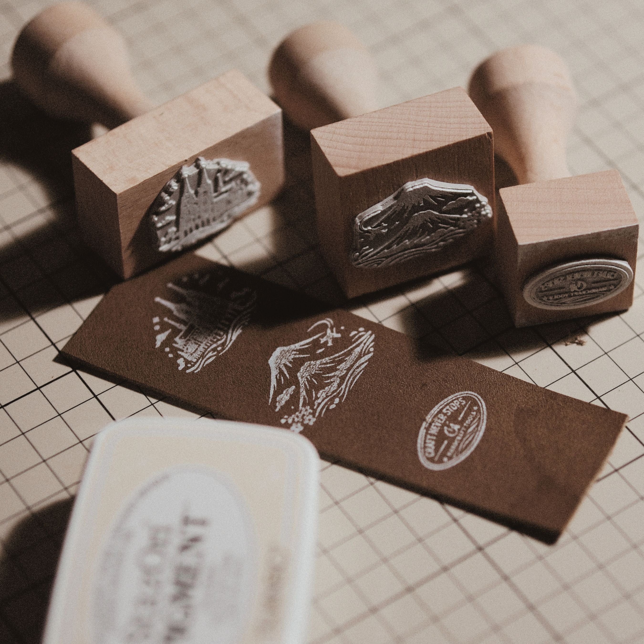 Custom wooden rubber stamp for leather, paper, cardboard, fabric, packaging, tags, and notebook covers. Made from your logo, text, or artwork, with a free Japanese ink pad included. Clean, handmade stamping for branding and packing. Send your design to get started.