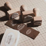 Custom wooden rubber stamp for leather, paper, cardboard, fabric, packaging, tags, and notebook covers. Made from your logo, text, or artwork, with a free Japanese ink pad included. Clean, handmade stamping for branding and packing. Send your design to get started.