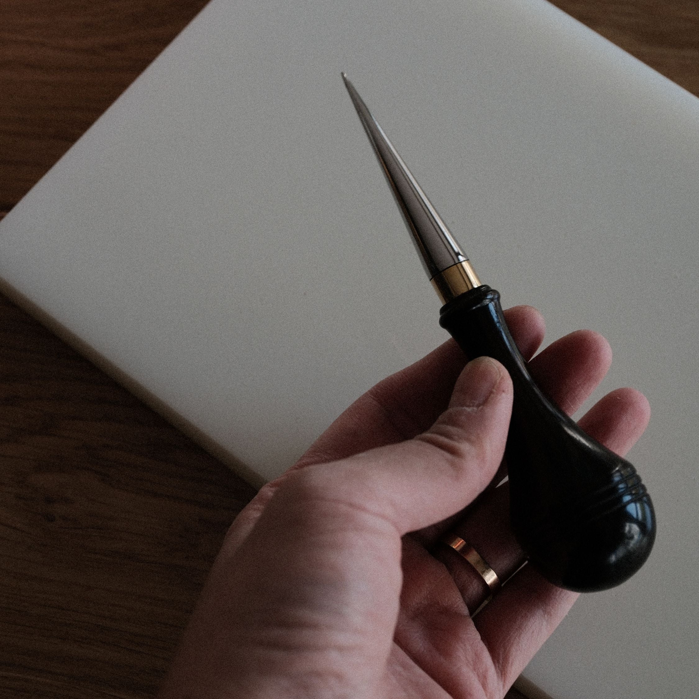Leathercraft scratch awl for marking lines, opening holes, and widening stitch holes. Made with a solid 304 stainless steel tip and rosewood handle for balanced everyday use in hand stitching and leatherworking. A useful bench tool for daily leathercraft work. Shop now.