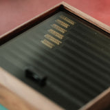 Modular walnut stamp box for Maxita brass letters. Freely arrange letters with movable modules that stay in place. Upgraded with a stable layout and glass lid for dust-free storage and display. A clean, flexible way to organize your type. Explore now.