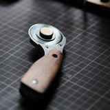 The Nattools Safety Rotary Leather Cutter is a compact, easy-to-control leather cutting tool with a retractable rotary blade, replaceable blade system, stainless steel body, and comfortable wooden handle. It is designed for smooth, safer, and less tiring cutting when working on leather straps, bag handles, panels, and pattern edges.