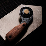 The Nattools Safety Rotary Leather Cutter is a compact, easy-to-control leather cutting tool with a retractable rotary blade, replaceable blade system, stainless steel body, and comfortable wooden handle. It is designed for smooth, safer, and less tiring cutting when working on leather straps, bag handles, panels, and pattern edges.