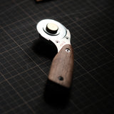 Cut leather more safely and smoothly with the Nattools rotary leather cutter. Features a retractable replaceable blade, stainless steel body, comfortable wooden handle, and safety lock for cleaner strap, bag, and pattern cutting. Shop now.
