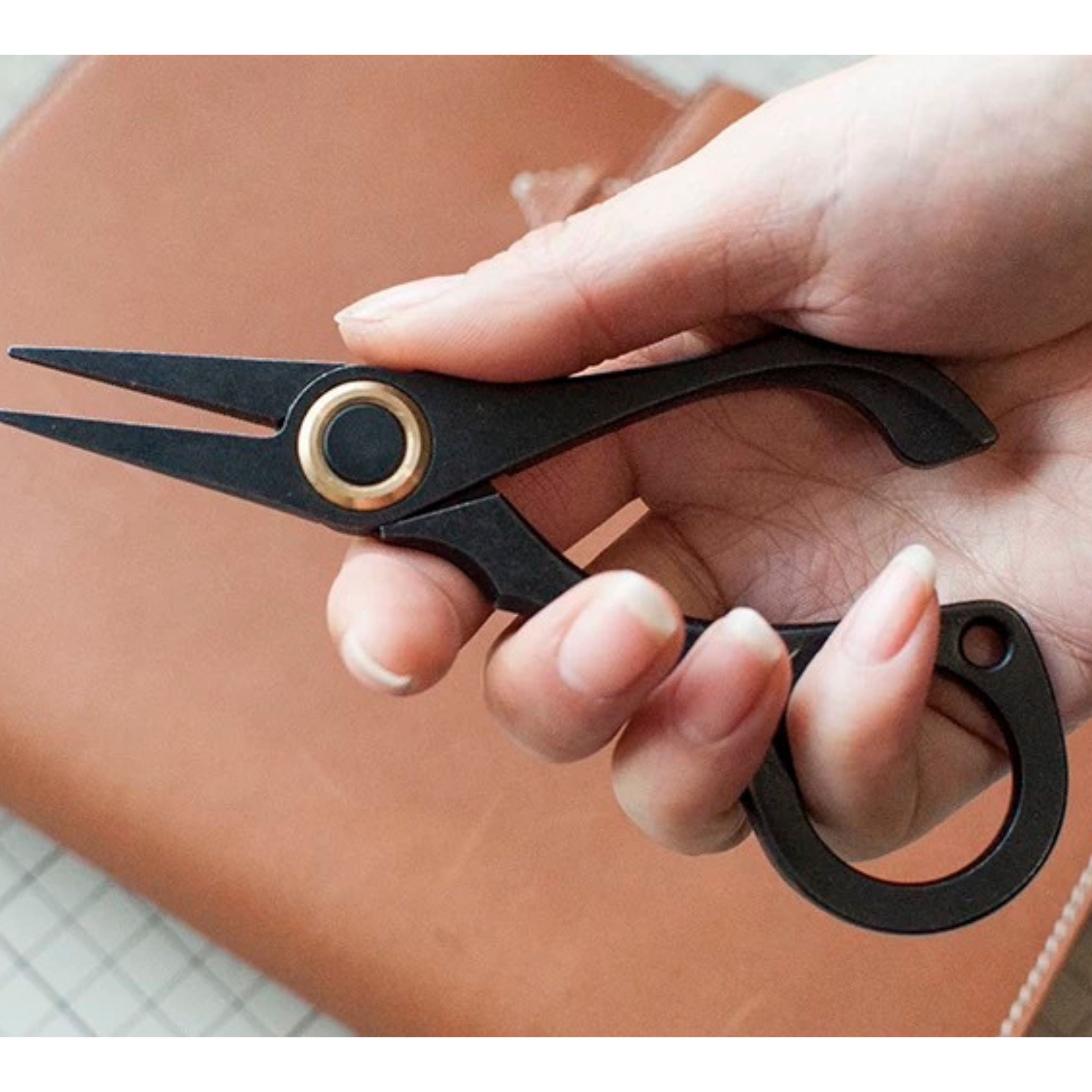 Stainless steel needle pulling pliers for leather hand stitching. Compact one-hand design with finger ring, spring-back jaw, and serrated flat tips to grip stuck needles through thick leather or tight stitch holes. Shop now.