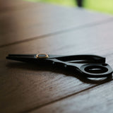 Stainless steel needle pulling pliers for leather hand stitching. Compact one-hand design with finger ring, spring-back jaw, and serrated flat tips to grip stuck needles through thick leather or tight stitch holes. Shop now.