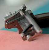 This modern leather strap cutter, developed in collaboration with Nattools, combines a rotating wheel with an automatic spring-back mechanism for smooth, consistent cuts on leather.