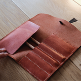 Leather pencil roll cutting die with integrated stitching holes, Japanese steel blade, and wood or acrylic base. Designed for clean, repeatable cutting with a protective pencil-tip flap. Custom layouts available for leathercraft projects. Order yours from CÍ.