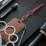 Customisable leather luggage tag cutting die with Japanese steel blade. Available with acrylic or wooden base, and can be made to your size, shape and hole layout. Ideal for leather luggage tags, bag tags and small leather goods.