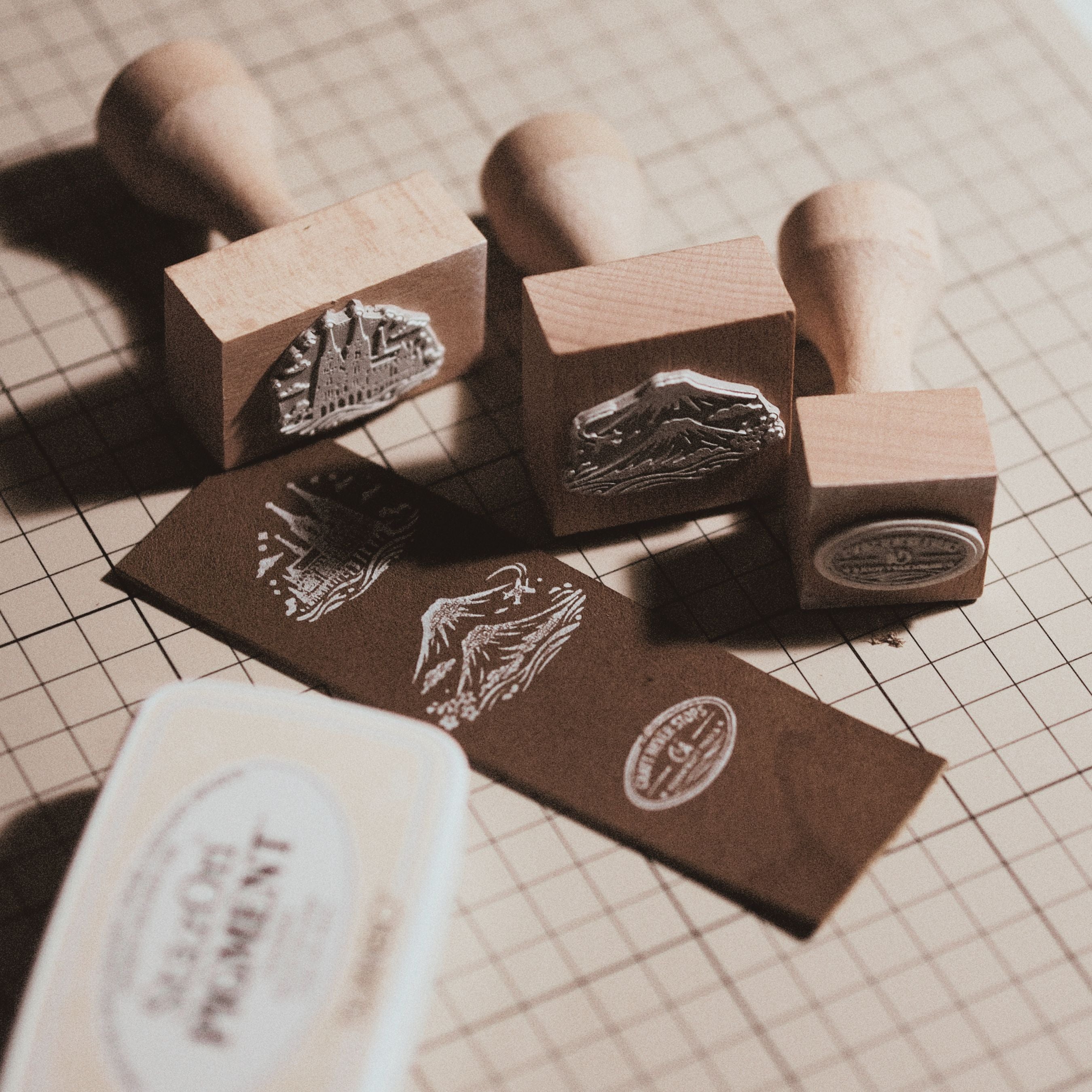 Custom wooden rubber stamp for leather, paper, cardboard, fabric, packaging, tags, and notebook covers. Made from your logo, text, or artwork, with a free Japanese ink pad included. Clean, handmade stamping for branding and packing. Send your design to get started.