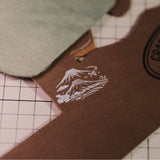 Custom wooden rubber stamp for leather, paper, cardboard, fabric, packaging, tags, and notebook covers. Made from your logo, text, or artwork, with a free Japanese ink pad included. Clean, handmade stamping for branding and packing. Send your design to get started.