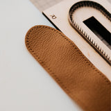 Custom leather pen sleeve cutting die with Japanese steel blade, wooden base, and built-in stitching holes. Made for clean cutting, accurate hole placement, and custom leather pen case production.