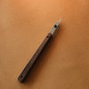 Slim leathercraft knife with replaceable blade, perfect for precision cutting, trimming corners, and fine detail work. Easy to use and swap blades with a hex key. A great tool for clean, controlled cuts. Add it to your leatherworking setup today.