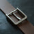 The overall design is simple yet rich in detail. The sleek side curves and smooth inner corners add to its minimalist elegance, giving it a refined, understated look. The buckle comes in a gray color that subtly shifts under different lighting conditions, creating a unique visual effect. We’ve provided photos with various backgrounds for you to see how it looks in different settings.