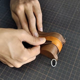 Black walnut strap molding tool with a fixed steel pin for secure strap hold. Simulates the natural wrist curve for more precise shaping. 